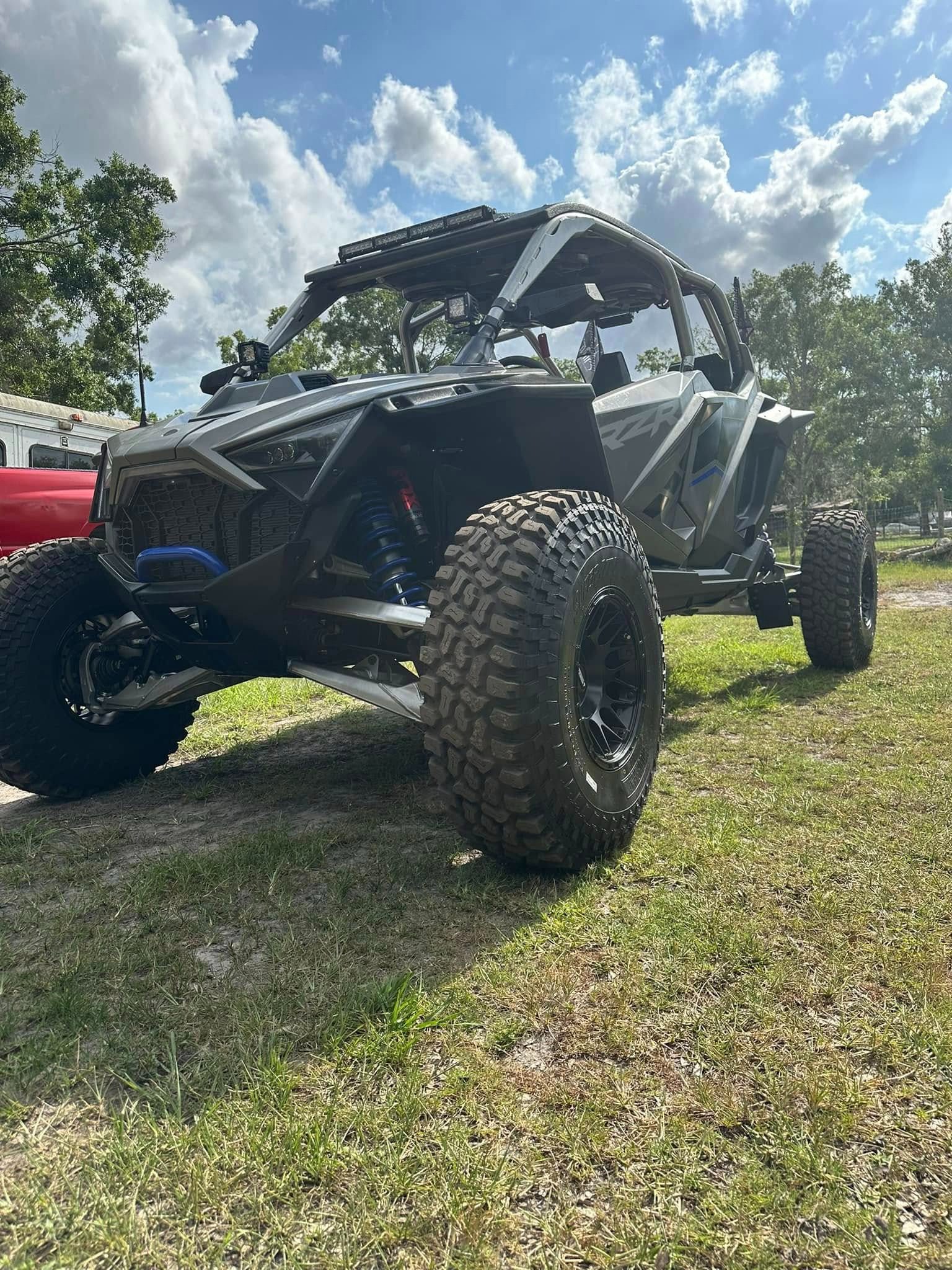 A black four wheel drive vehicle parked in the grass.