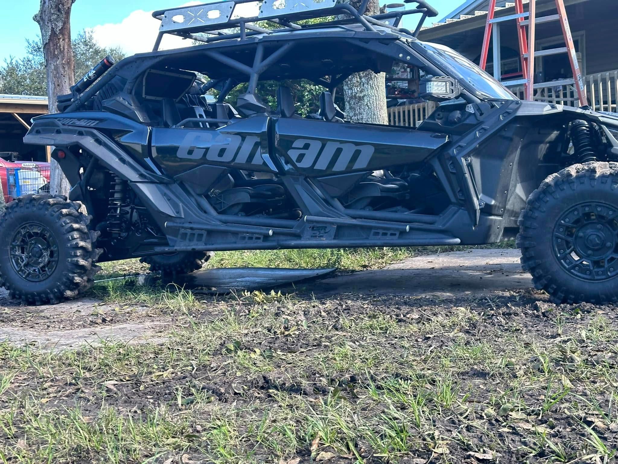 A black four wheeler parked in the grass.