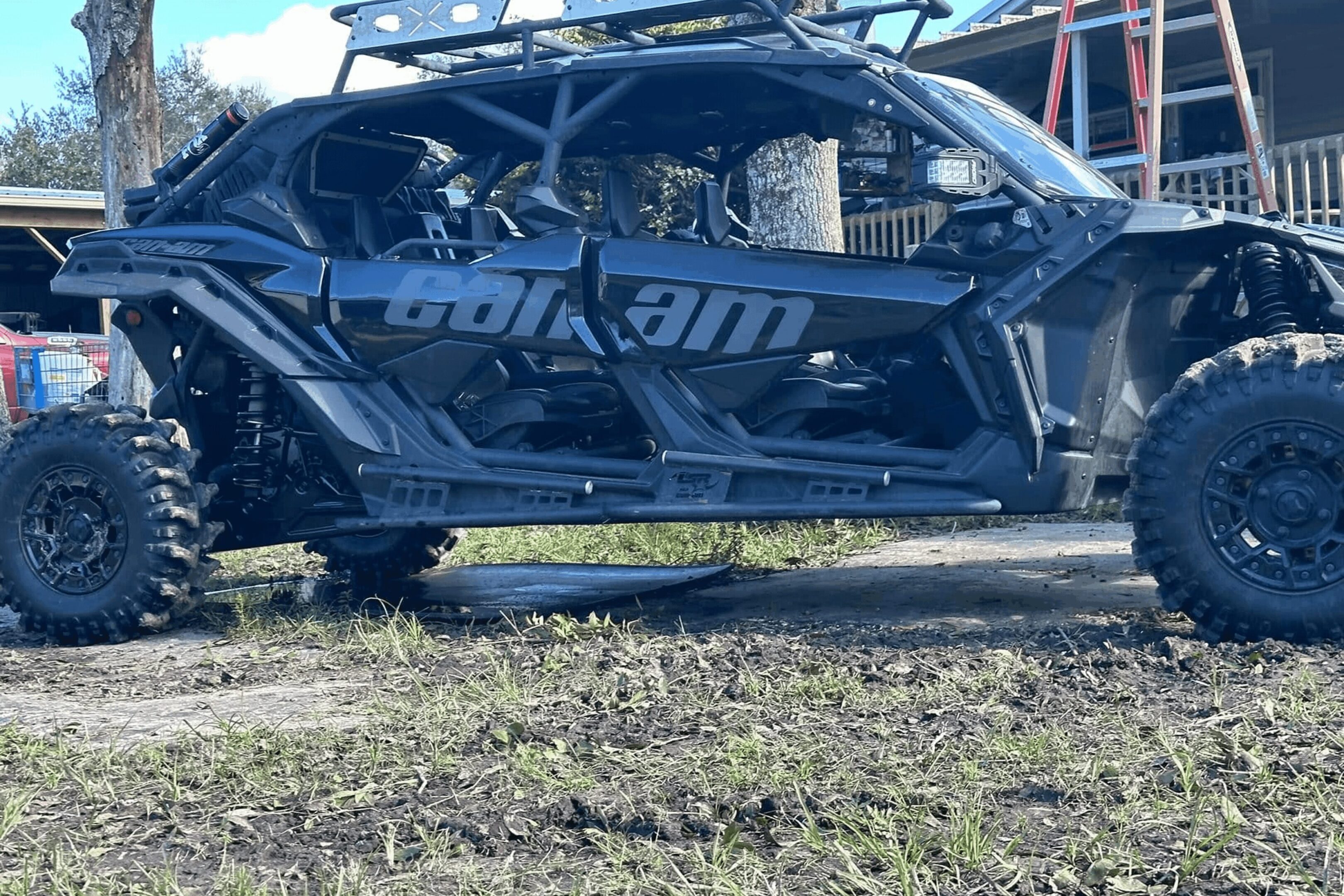 A black vehicle is parked on the grass.