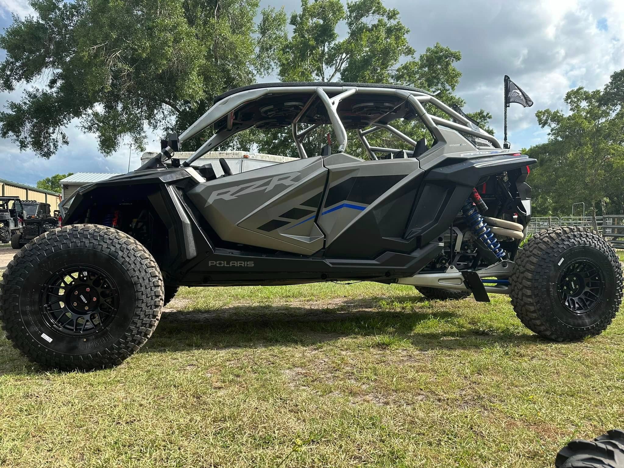 A large off road vehicle parked in the grass.