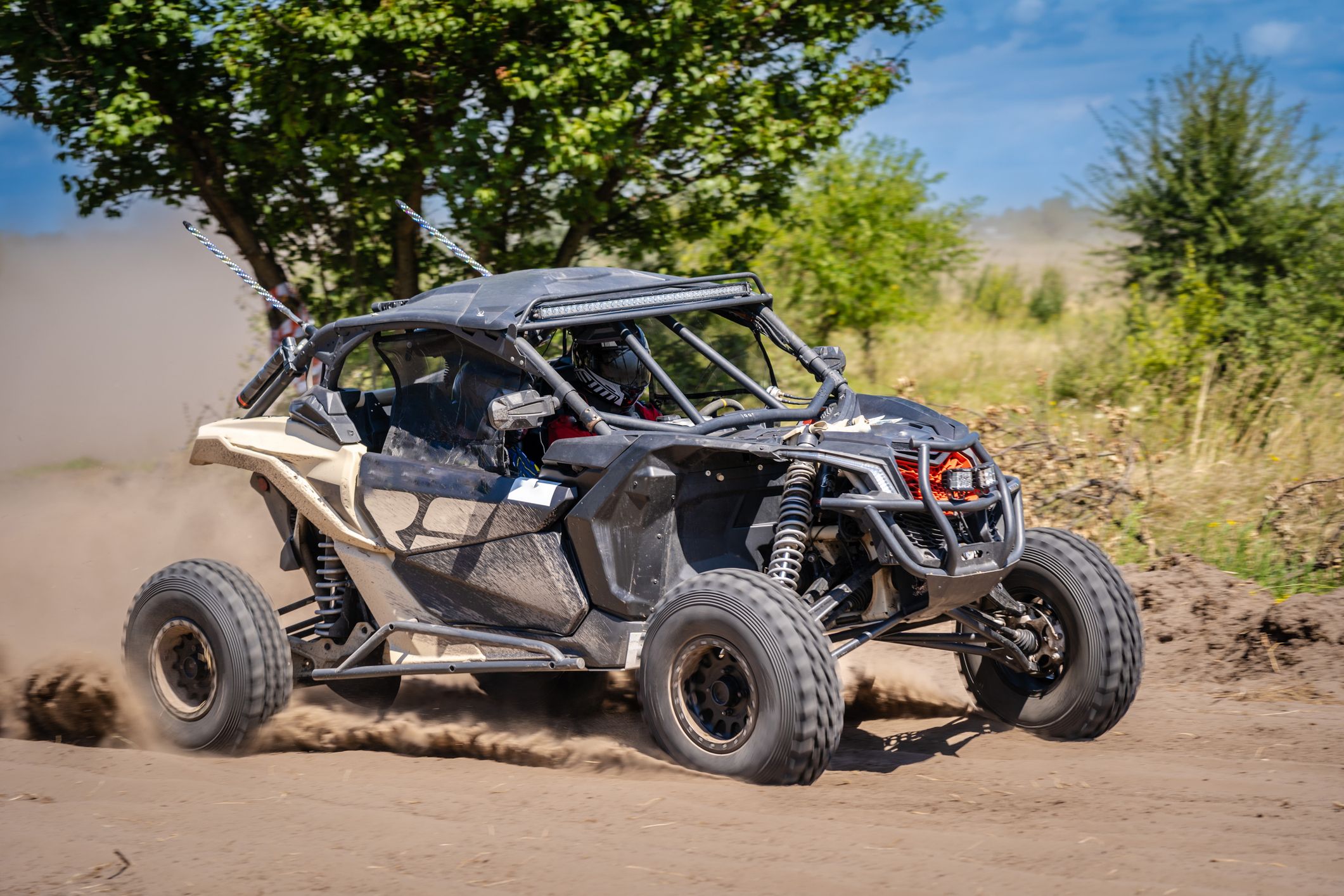 Off-road vehicle racing on a dirt track.