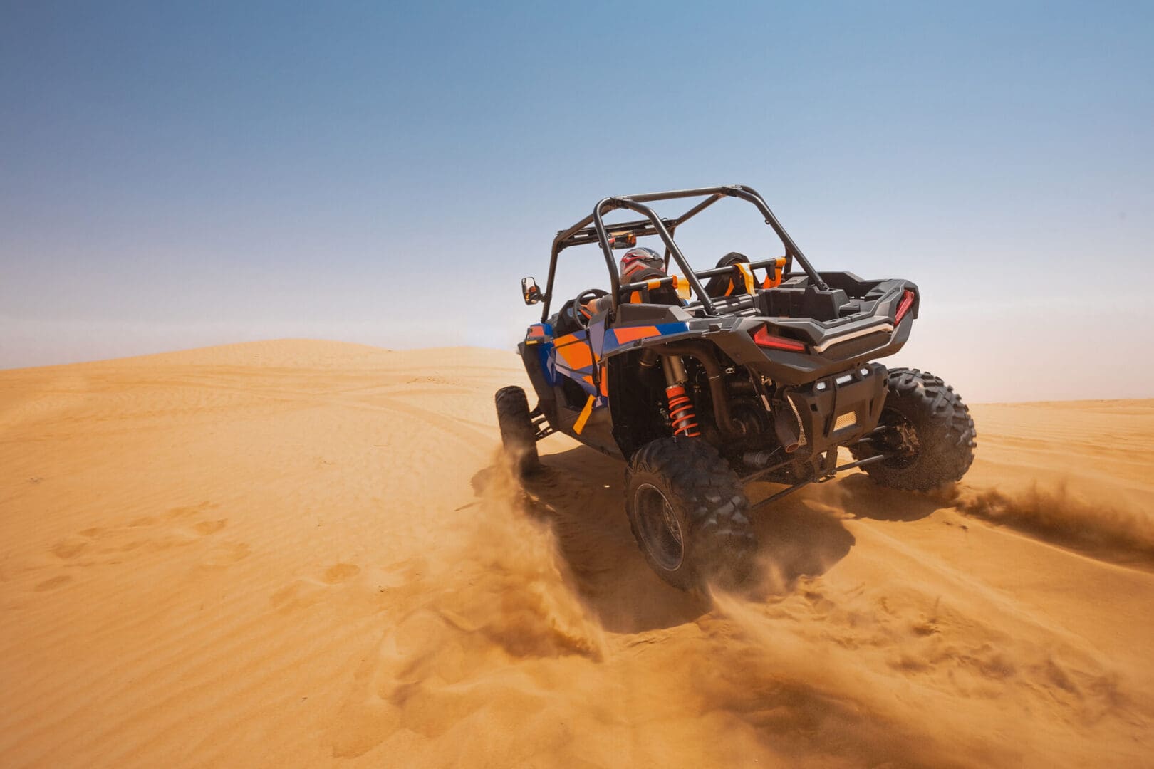 Utility buggy carving through sand dunes