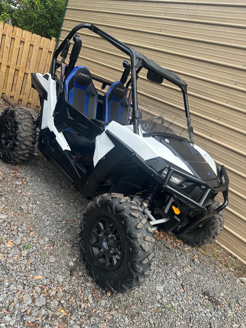 White side-by-side off-road vehicle parked